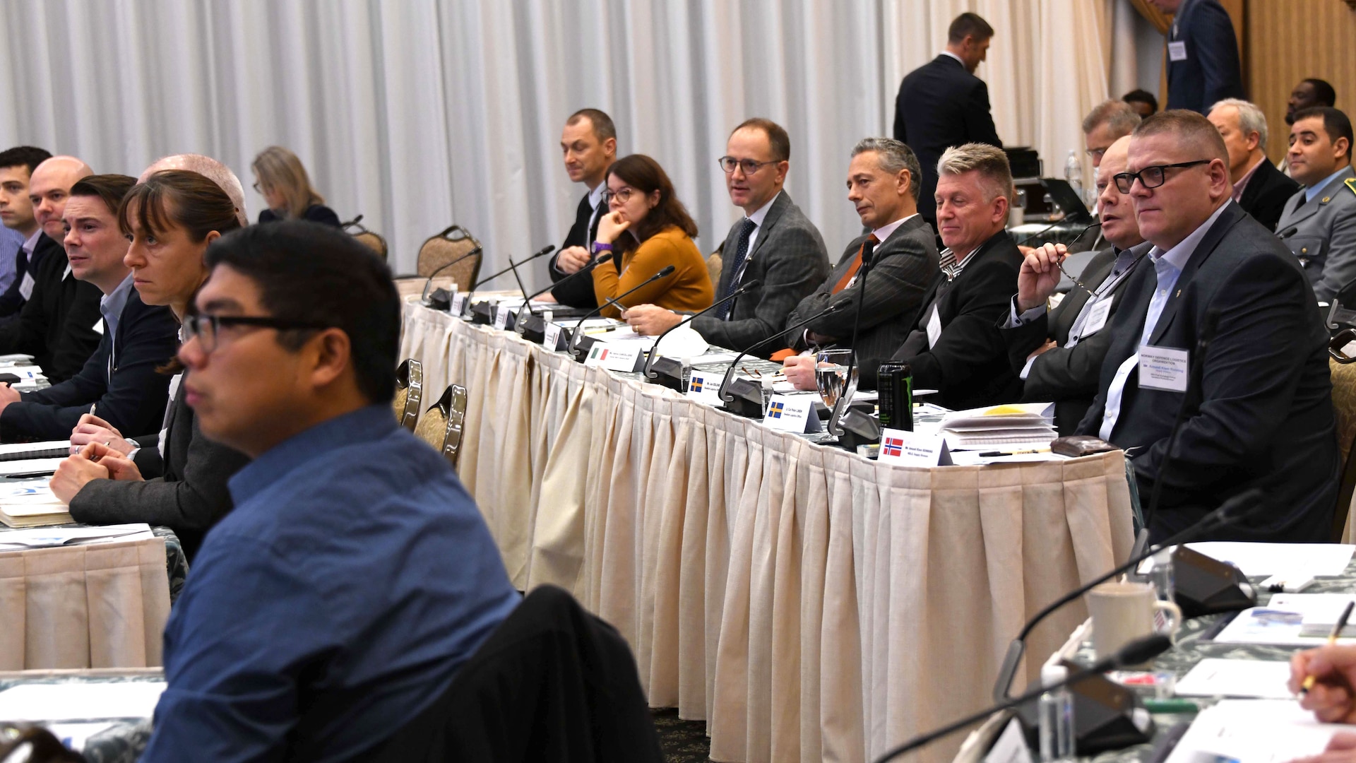 a group of people look toward stage during a conference