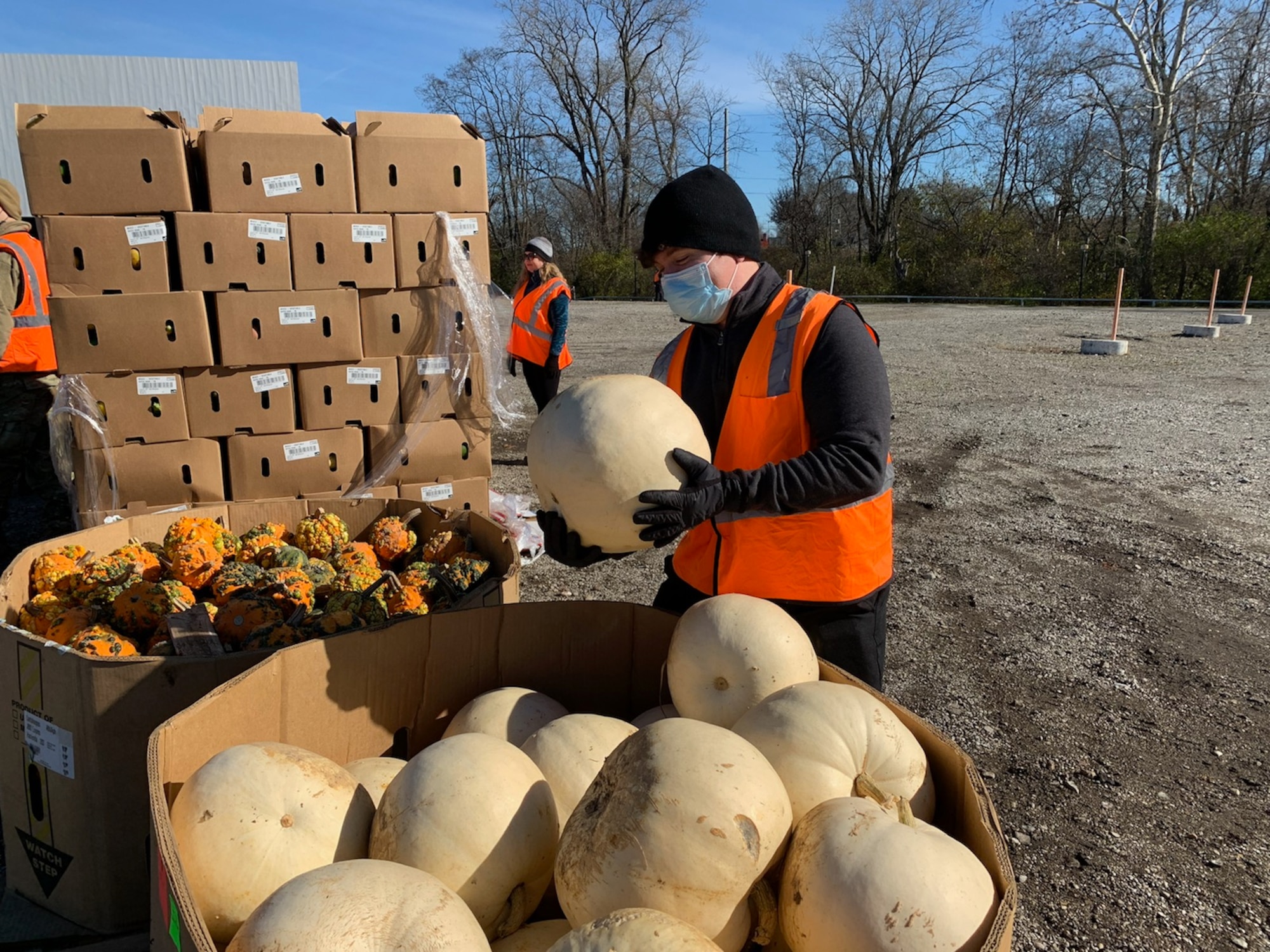 Diego Quevedo of the National Air and Space Intelligence Center examines vegetables donated to The Foodbank for Dayton families. The event supplied 1,728 families with Thanksgiving essentials. (Contributed photo)