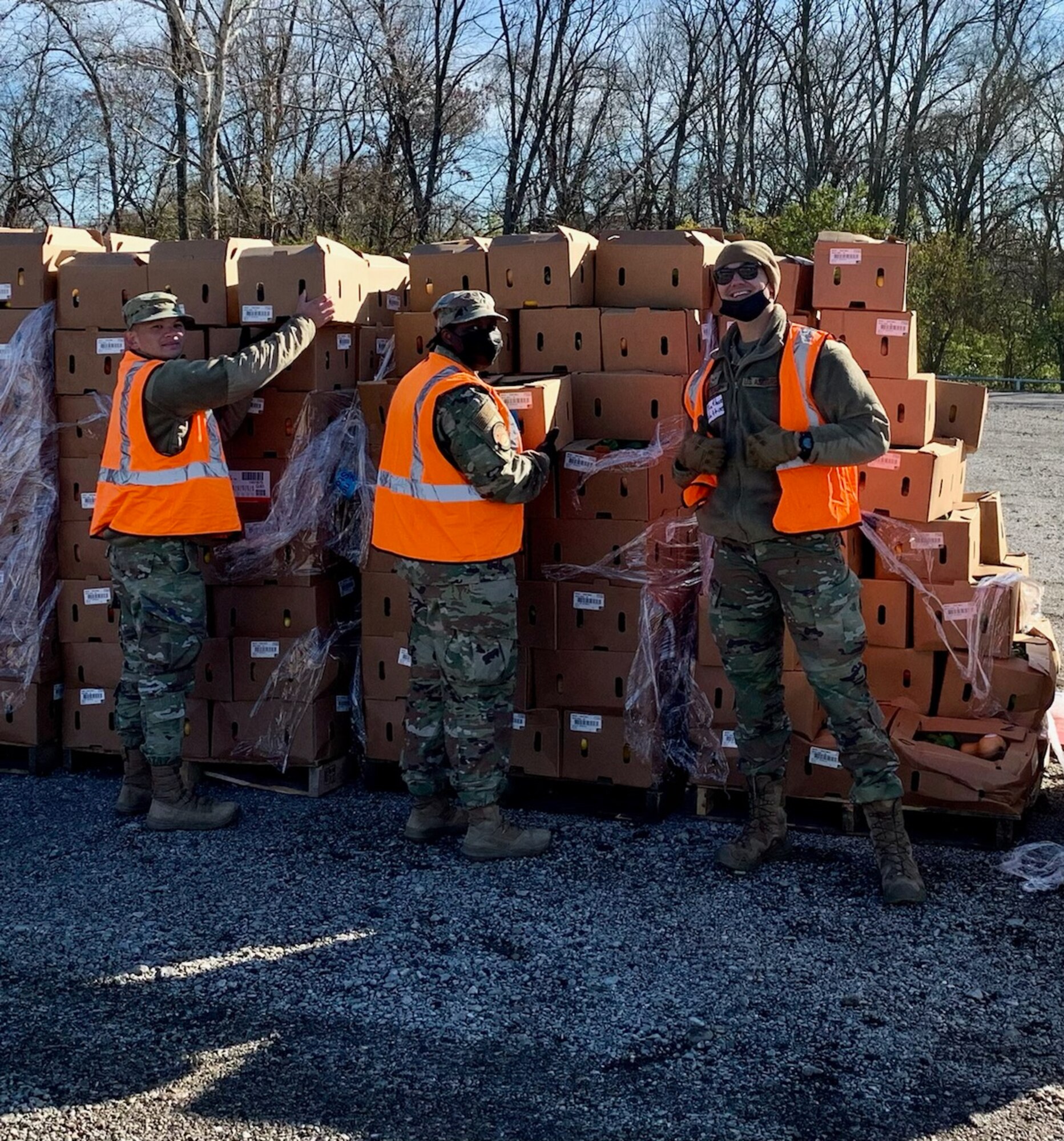 Airman 1st Class Jasper Kaamino, Staff Sgt. Stacy Thomas and Senior Airman Nathan Watkins prepare to hand out boxes of food as part of The Foodbank’s distribution Nov. 23. (Contributed photo)