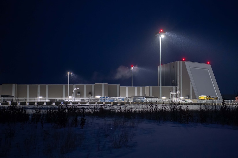 A photo of a military complex shows a large pyramid-shaped building.