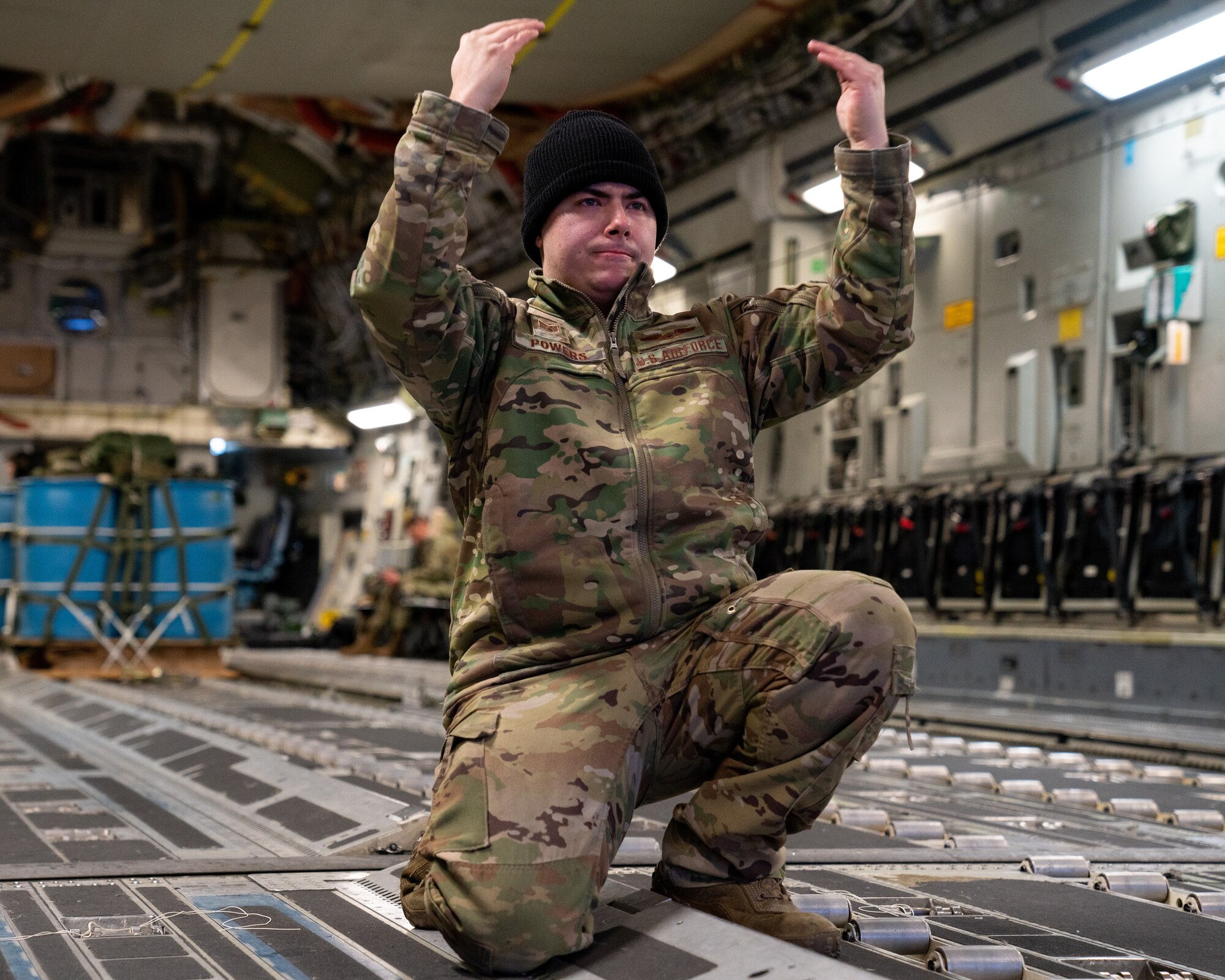 U.S. Air Force Staff Sgt. Anthony Powers, a 3rd Operations Support Squadron loadmaster, guides a cargo pallet onto a 517th Airlift Squadron C-17 Globemaster III.