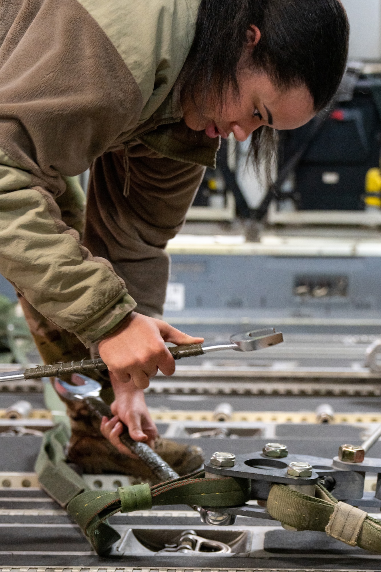 U.S. Air Force Staff Sgt Darian Johnson, a 3rd Operations Support Squadron loadmaster, secures a cargo pallet to a C-17 Globemaster III.