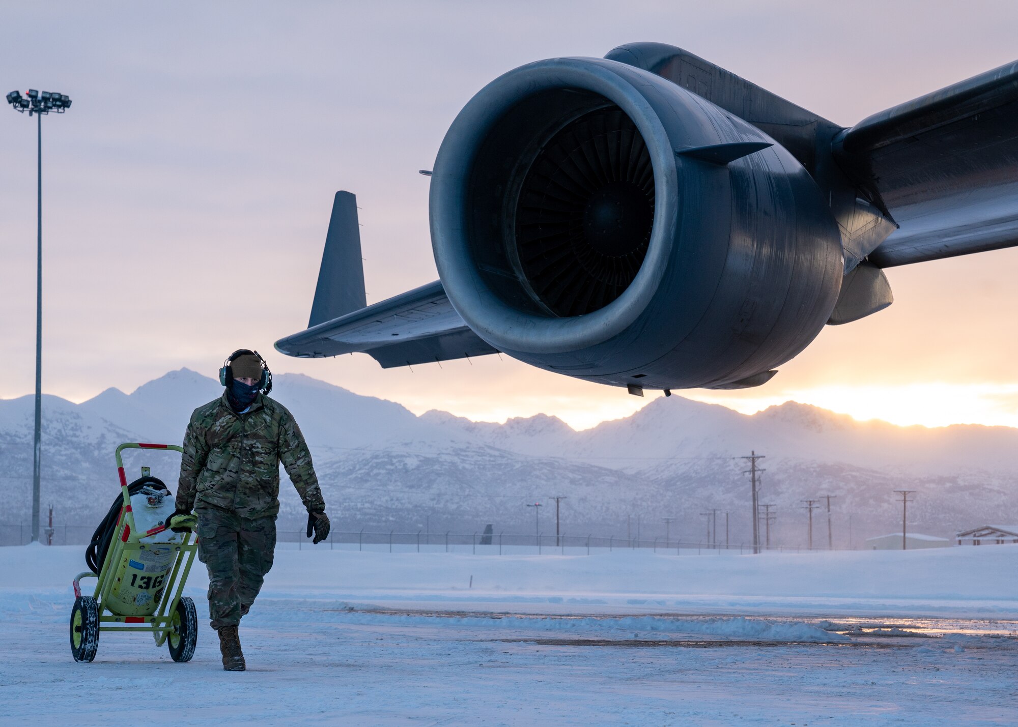 U.S. Air Force Senior Airman Oscar Oliver, a 703d Aircraft Maintenance Squadron crew chief, pulls a fire-suppression bottle.