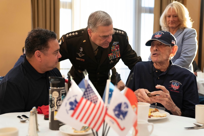 An older gentleman speaks with an Army general.