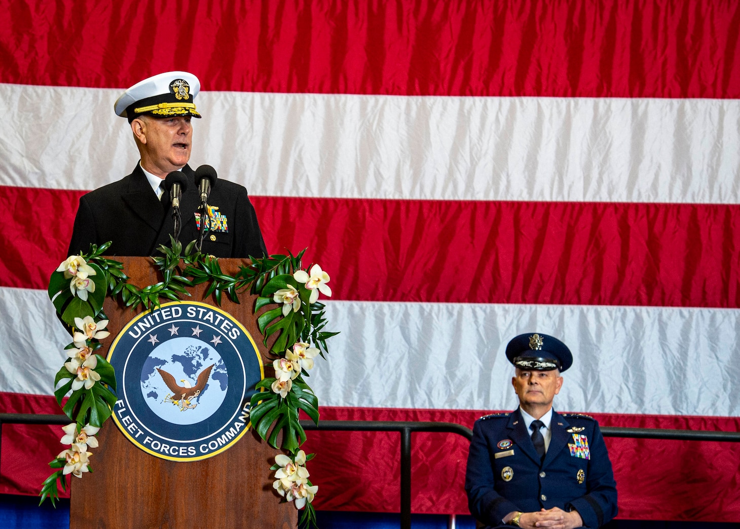 Adm. Christopher W. Grady, commander, U.S. Fleet Forces Command (USFFC) delivers his final remarks before being relieved by Adm. Daryl Caudle, not shown, during the USFFC change of command ceremony aboard USS George H. W. Bush (CVN 77), Dec. 7, 2021.