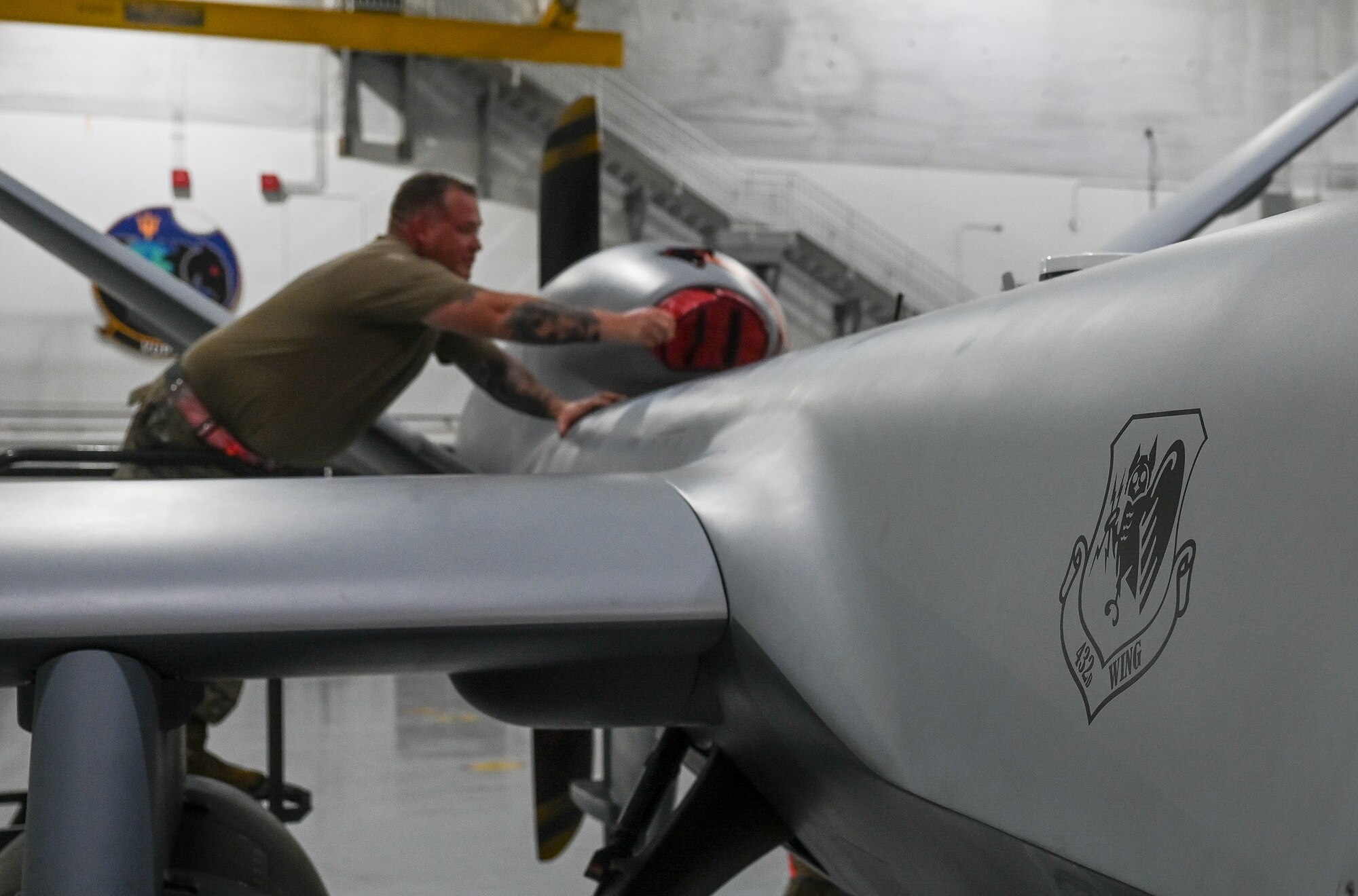 Airmen from the 556th Test and Evaluation Squadron preflight a MQ-9 Reaper at Andersen Air Force Base, Guam, Oct. 4, 2021. The Reaper was flown from Marine Corps Base, Hawaii, during its participation in Exercise Ace Reaper.  The purpose of ACE Reaper is to demonstrate the MQ-9’s capabilities and service members’ abilities to rapidly mobilize and integrate across multiple domains. The exercise also serves as an opportunity to train in a maritime environment and in a different airspace. (U.S. Air Force photo by Staff Sgt. Divine Cox)