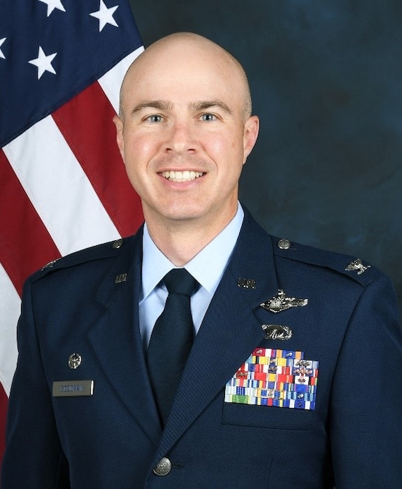 photo of U.S. Air Force officer with U.S. Flag in background