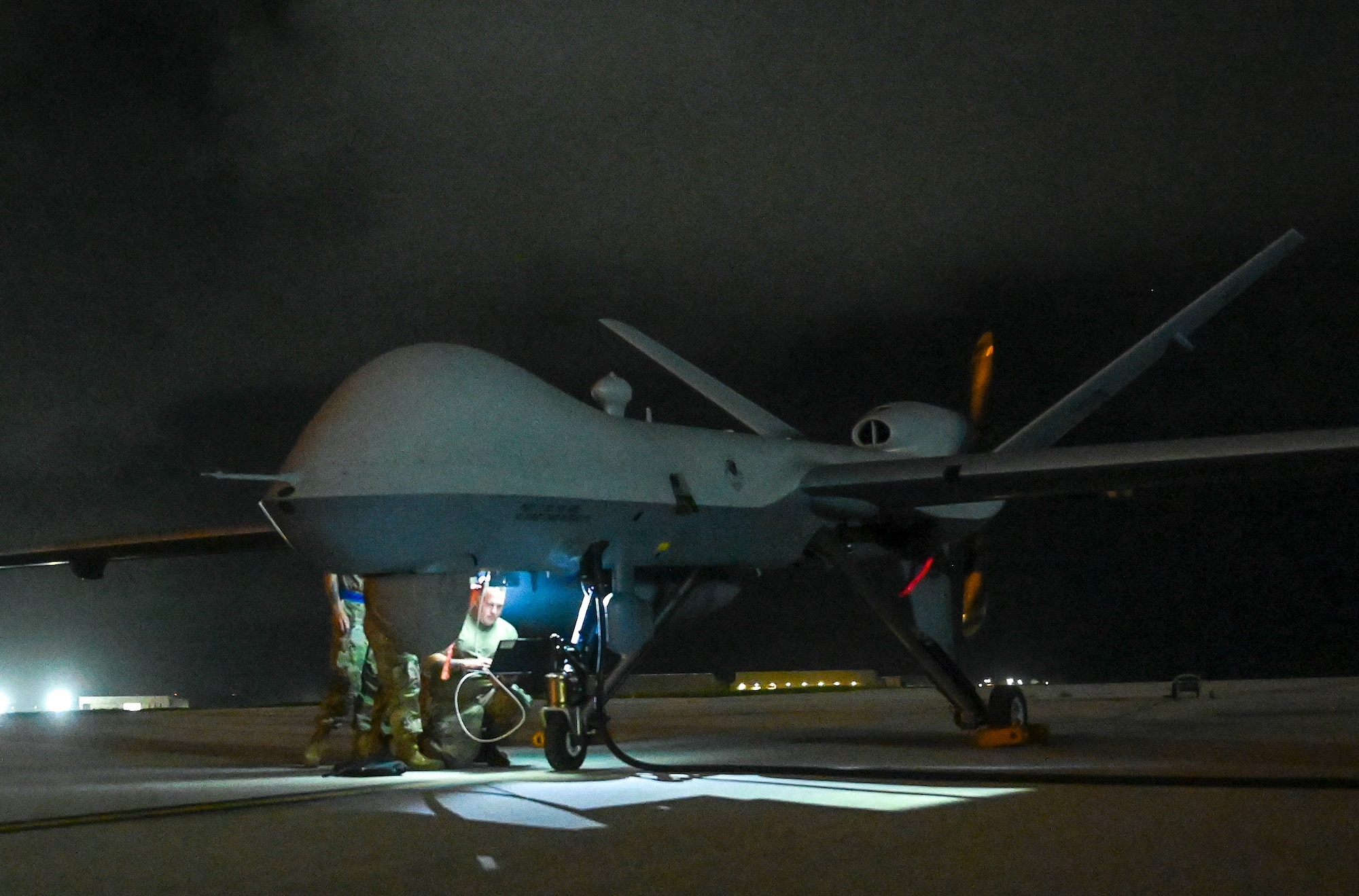 Airmen from the 556th Test and Evaluation Squadron preflight a MQ-9 Reaper at Andersen Air Force Base, Guam, Oct. 4, 2021. The Reaper was flown from Marine Corps Base, Hawaii, during its participation in Exercise Ace Reaper.  The purpose of ACE Reaper is to demonstrate the MQ-9’s capabilities and service members’ abilities to rapidly mobilize and integrate across multiple domains. The exercise also serves as an opportunity to train in a maritime environment and in a different airspace. (U.S. Air Force photo by Staff Sgt. Divine Cox)