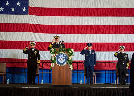 Adm. Christopher W. Grady, commander, U.S. Fleet Forces Command (USFFC), center, Adm. Charles Richard, commander, U.S. Strategic Command, left, Air Force Gen. Glen VanHerck, commander, U.S. Northern Command, and Adm. Daryl Caudle give a collective salute during the USFFC change of command ceremony aboard USS George H. W. Bush (CVN 77), Dec. 7, 2021.
