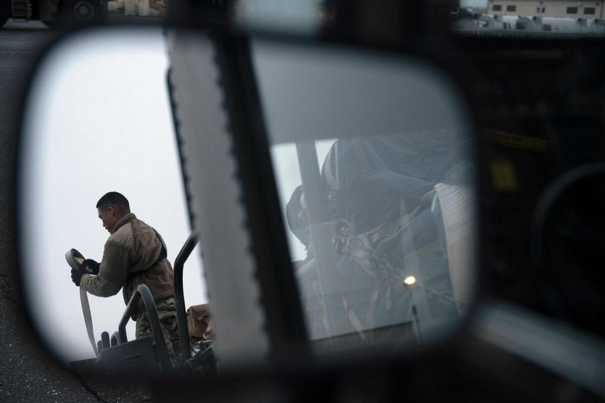 Photos of Airmen palletizing and loading water bottles and supplies into a C-5 for Hawaii