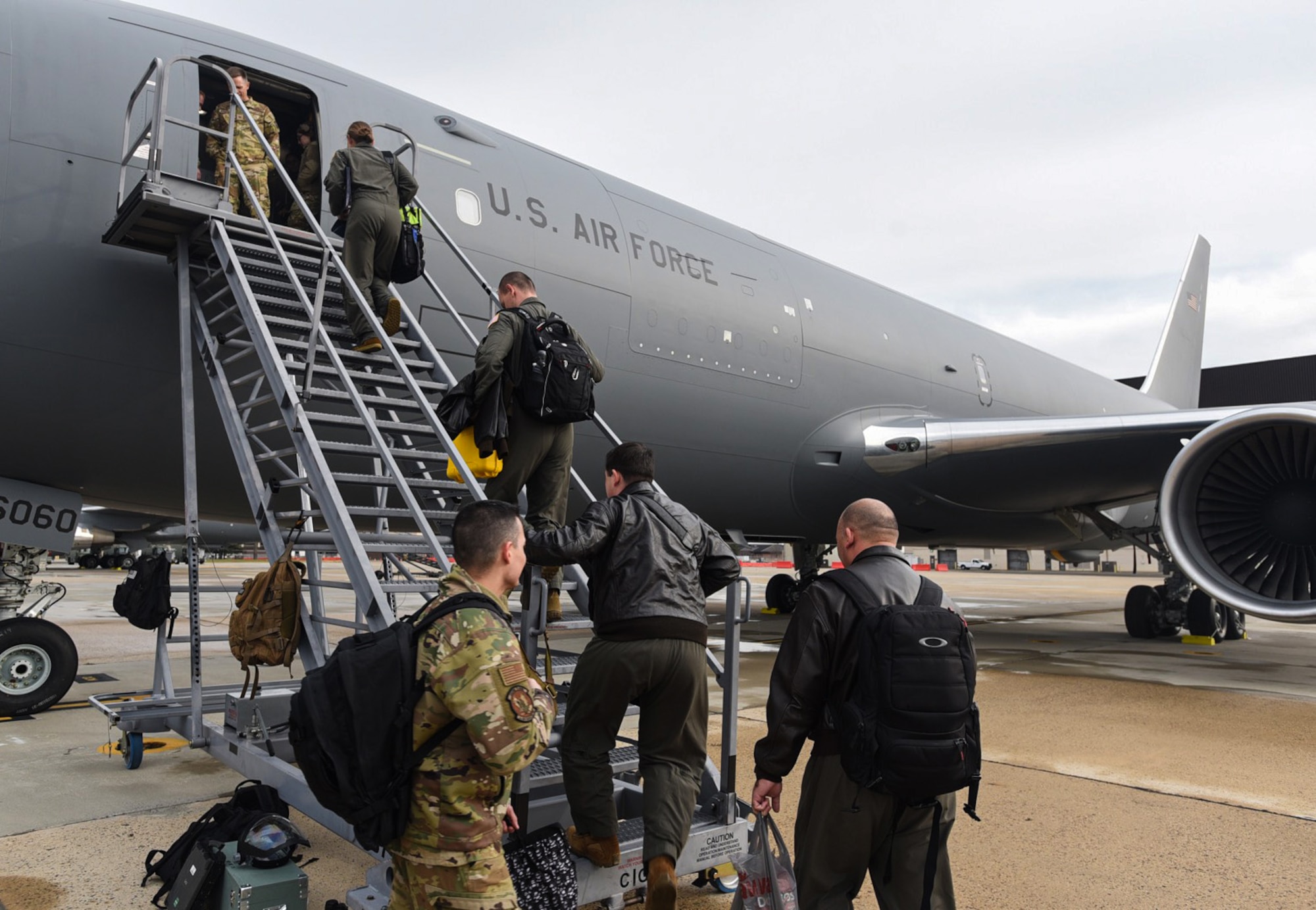 An aircrew boards  a KC-46 Pegasus aircraft for its first mission on Joint Base McGuire-Dix-Lakehurst, New Jersey Dec. 2, 2021. Less than a month after being in the 305th and 514th Air Mobility Wings’ control, the first two KC-46 aircrafts assigned here were tasked with their first mission to test the operation and maintenance processes put in place prior to the aircrafts arrival. (U.S. Air Force photo by Senior Airman Ariel Owings)