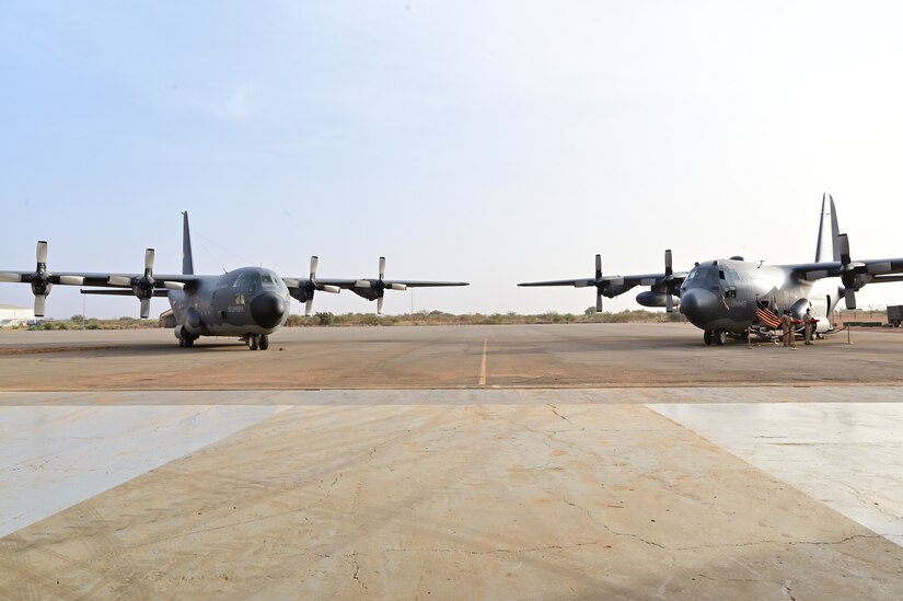 Two aircraft parked on flightline.