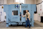 Norfolk Naval Shipyard (NNSY) Technology and Innovation (T&I) Additive Manufacturing (AM) Center of Excellence (CoE) Project Manager and AM Lead Jessica Roberts shares one of the 3-D metal printers that are being set up at the shipyard.