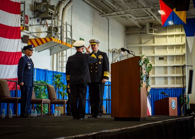 Adm. Christopher W. Grady, left, is relieved as commander, U.S. Fleet Forces Command (USFFC) by Adm. Daryl Caudle during the USFFC change of command ceremony aboard USS George H. W. Bush (CVN 77), Dec. 7, 2021.