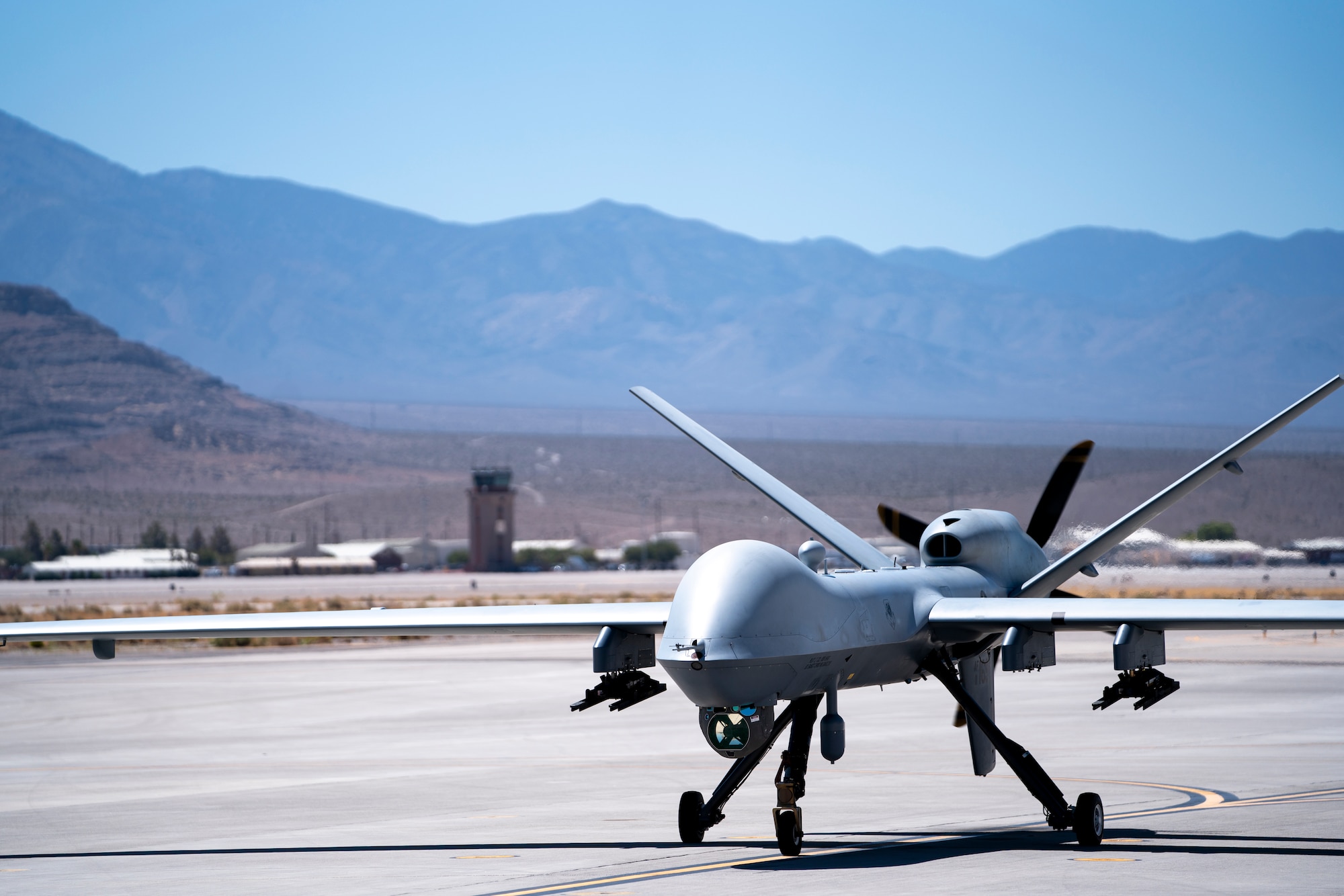 A U.S. Air Force MQ-9 Reaper taxis in for a warm refuel test, where the aircraft is grounded and refueled while powered on but with the engine not running, at Creech Air Force Base, Nevada, Sept. 2, 2021. Warm refuels can increase the MQ-9’s operational agility through reducing turnaround time on the ground. (U.S. Air Force photo by Tech. Sgt. Emerson Nuñez)