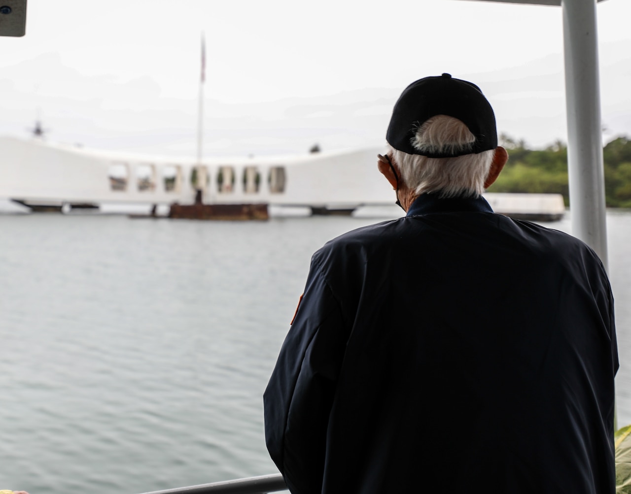Mr. Ronald G. Scharfe, a World War II veteran, observes the USS Arizona Memorial during a World War II veterans harbor tour as part of the 80th Anniversary Pearl Harbor Remembrance.