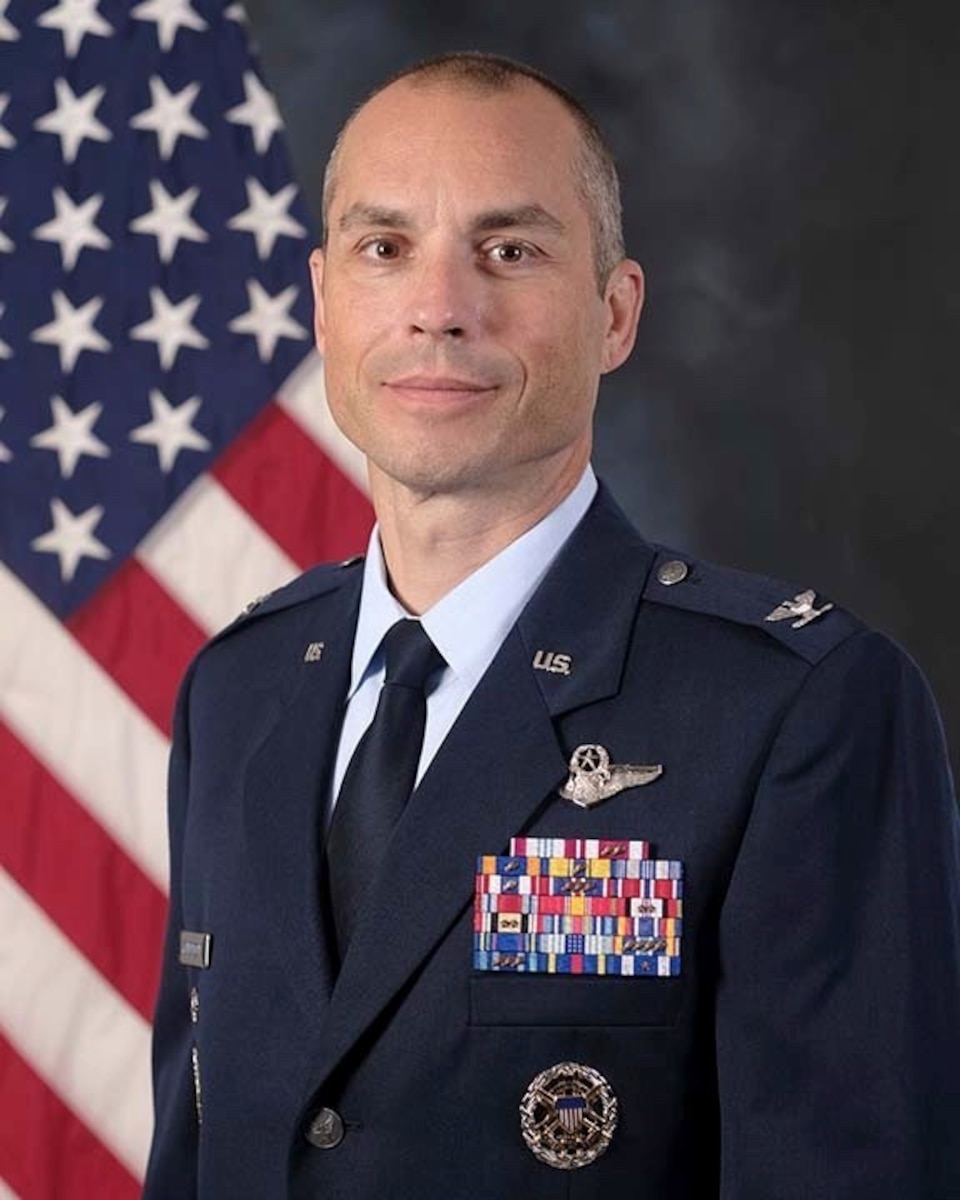 photo of U.S. Airmen with U.S. Flag in background