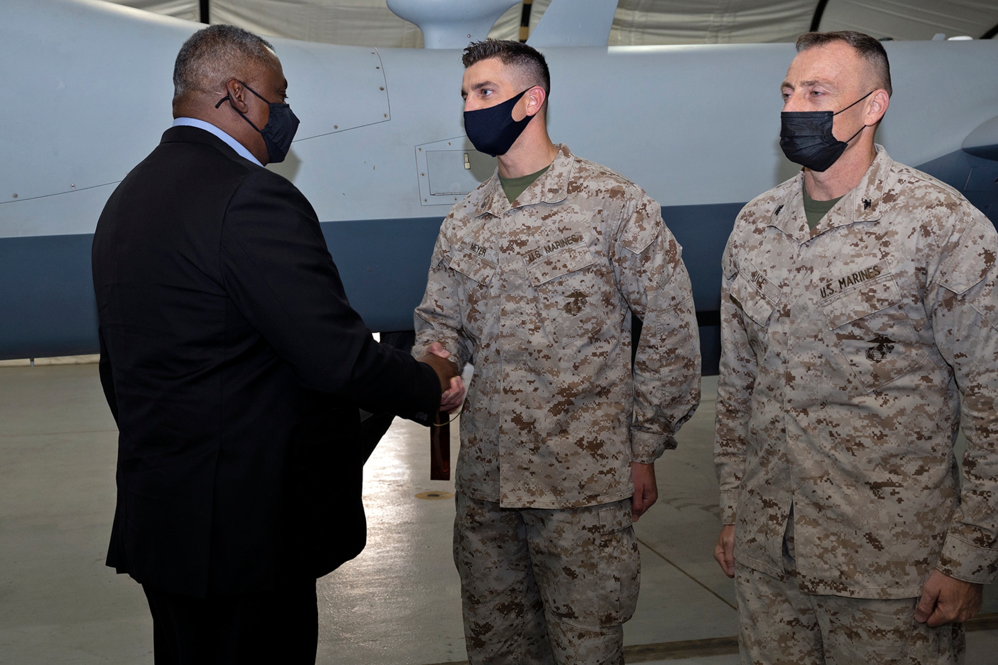 Secretary of Defense Lloyd J. Austin III coins U.S. Marine Maj. Robert Meyer at Al Dhafra Air Base, United Arab Emirates, Nov. 22, 2021. Austin Traveled to the UAE to meet with senior government officials to reaffirm the US-UAE strategic partnership.