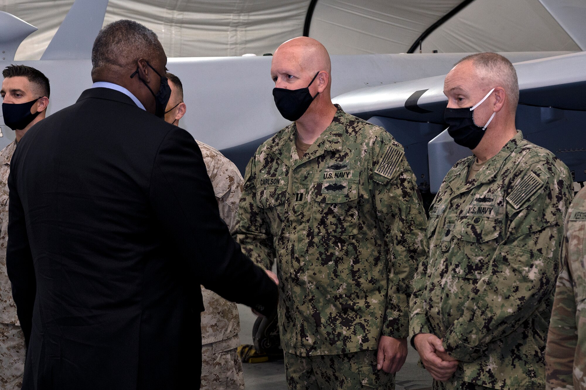 Secretary of Defense Lloyd J. Austin III coins Navy Lt. Nathan Carlson at Al Dhafra Air Base, United Arab Emirates, Nov. 22, 2021. Austin Traveled to the UAE to meet with senior government officials to reaffirm the US-UAE strategic partnership.