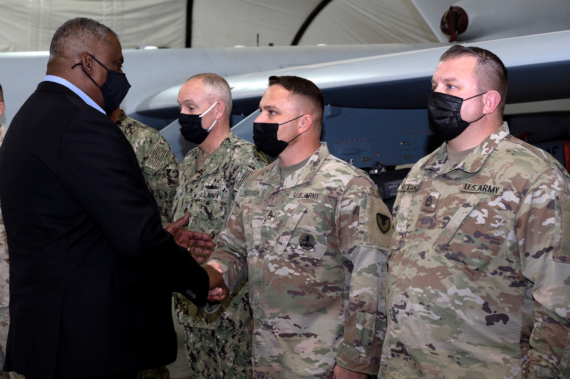 Secretary of Defense Lloyd J. Austin III coins Sgt. 1st Class Justin Kesterson at Al Dhafra Air Base, United Arab Emirates, Nov. 22, 2021. Austin Traveled to the UAE to meet with senior government officials to reaffirm the US-UAE strategic partnership.