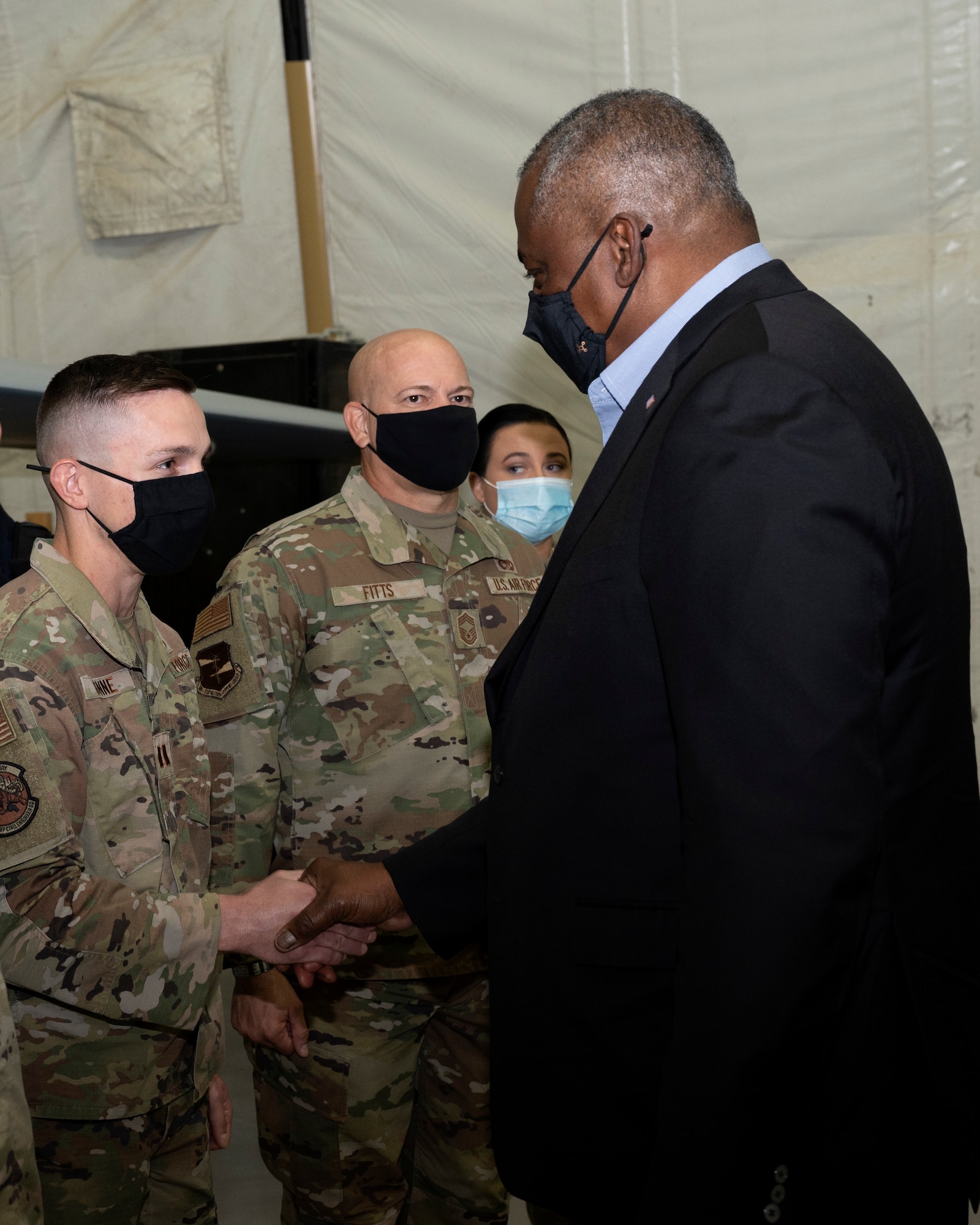 Secretary of Defense Lloyd J. Austin III coins U.S. Air Force Capt. Adam Dunne at Al Dhafra Air Base, United Arab Emirates, Nov. 22, 2021. Austin Traveled to the UAE to meet with senior government officials to reaffirm the US-UAE strategic partnership.