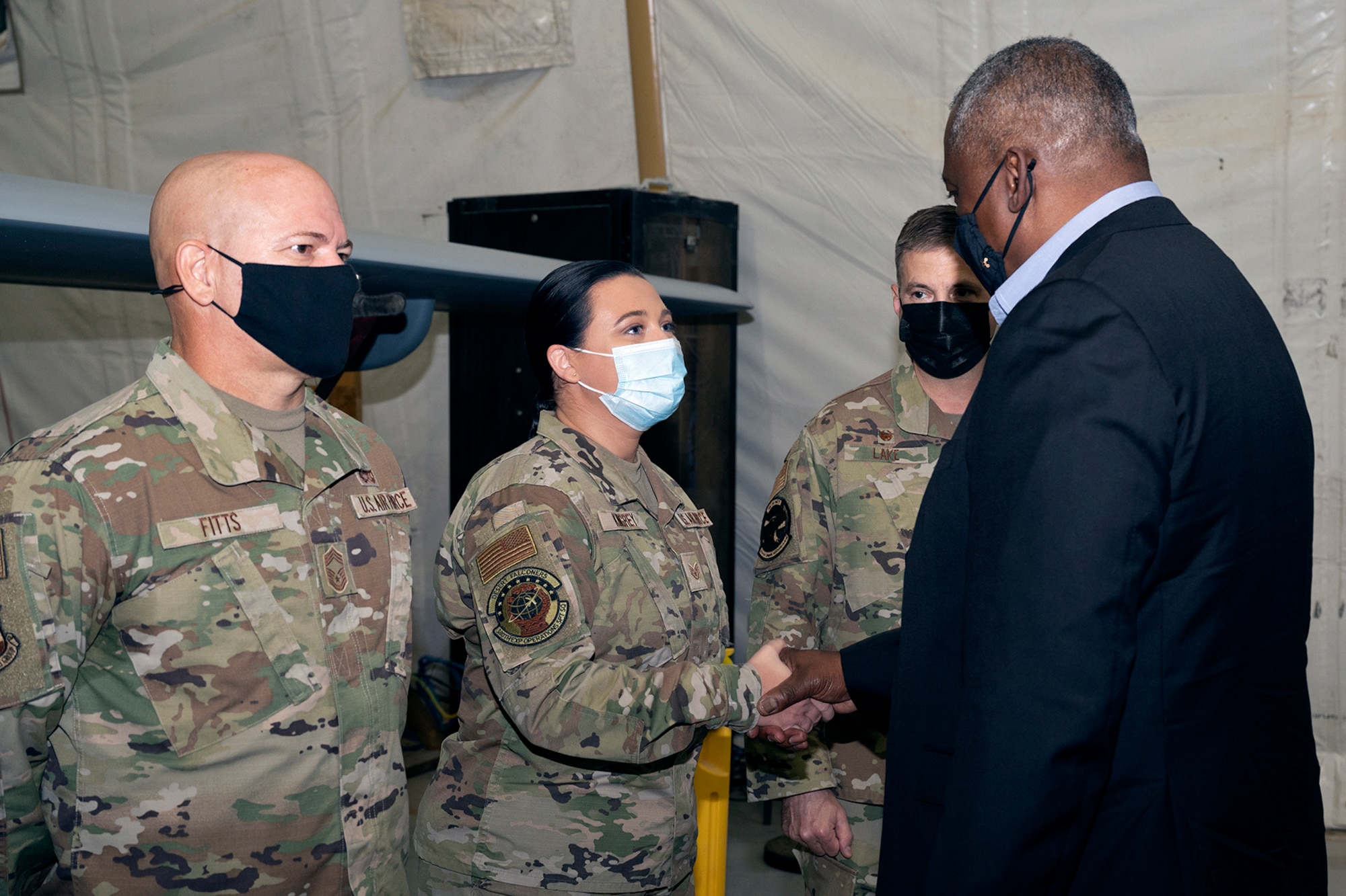 Secretary of Defense Lloyd J. Austin III coins U.S. Air Force Staff Sgt. Riann Kingrey at Al Dhafra Air Base, United Arab Emirates, Nov. 22, 2021. Austin Traveled to the UAE to meet with senior government officials to reaffirm the US-UAE strategic partnership.