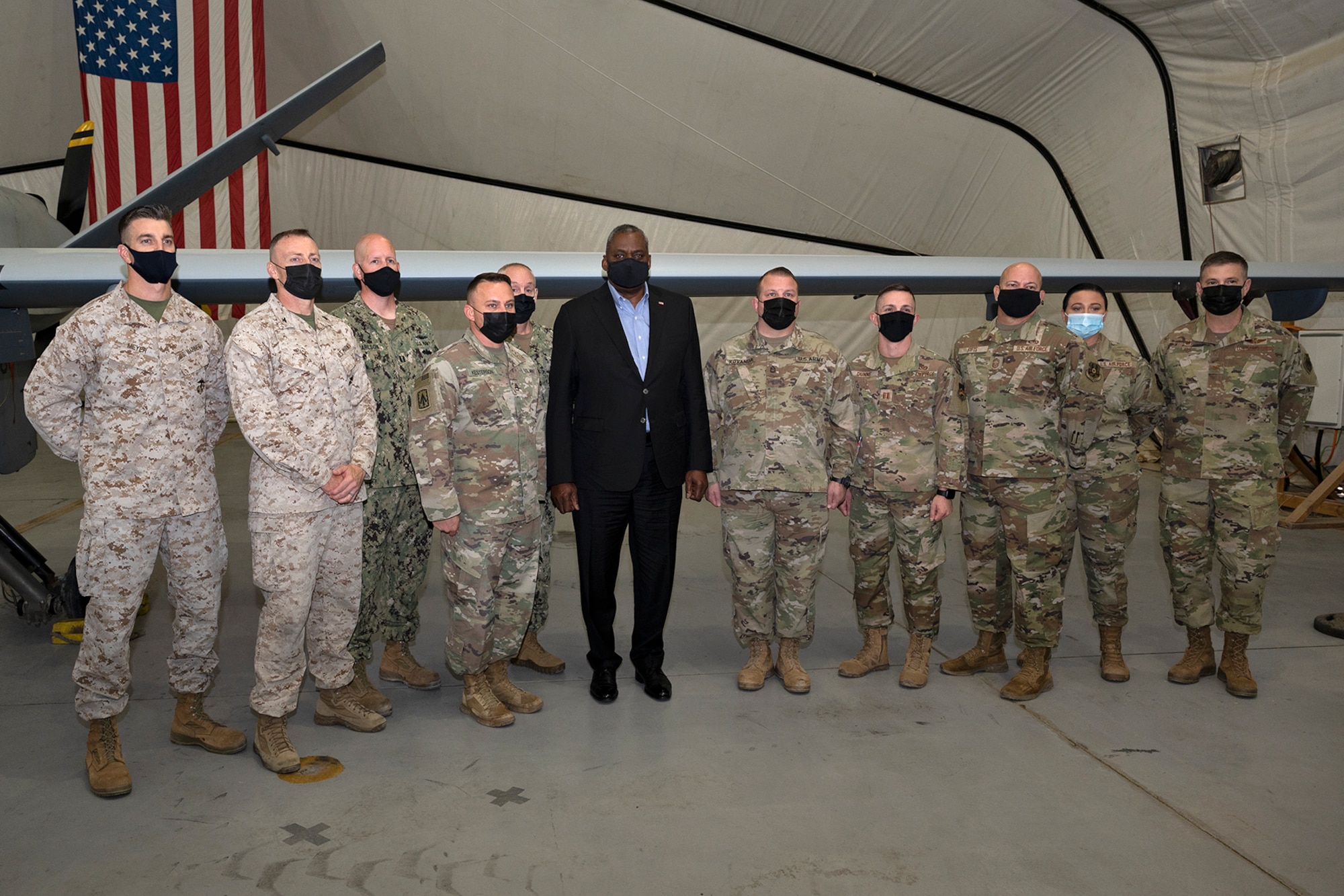 Secretary of Defense Lloyd J. Austin III poses with military members at Al Dhafra Air Base, United Arab Emirates, Nov. 22, 2021. Austin Traveled to the UAE to meet with senior government officials to reaffirm the US-UAE strategic partnership.