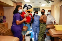 Yardbird Sam and blood drive volunteers gives the thumbs up at a recent blood drive at Norfolk Naval Shipyard.
