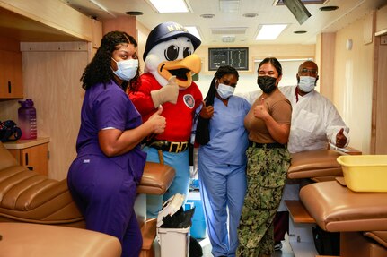 Yardbird Sam and blood drive volunteers gives the thumbs up at a recent blood drive at Norfolk Naval Shipyard.