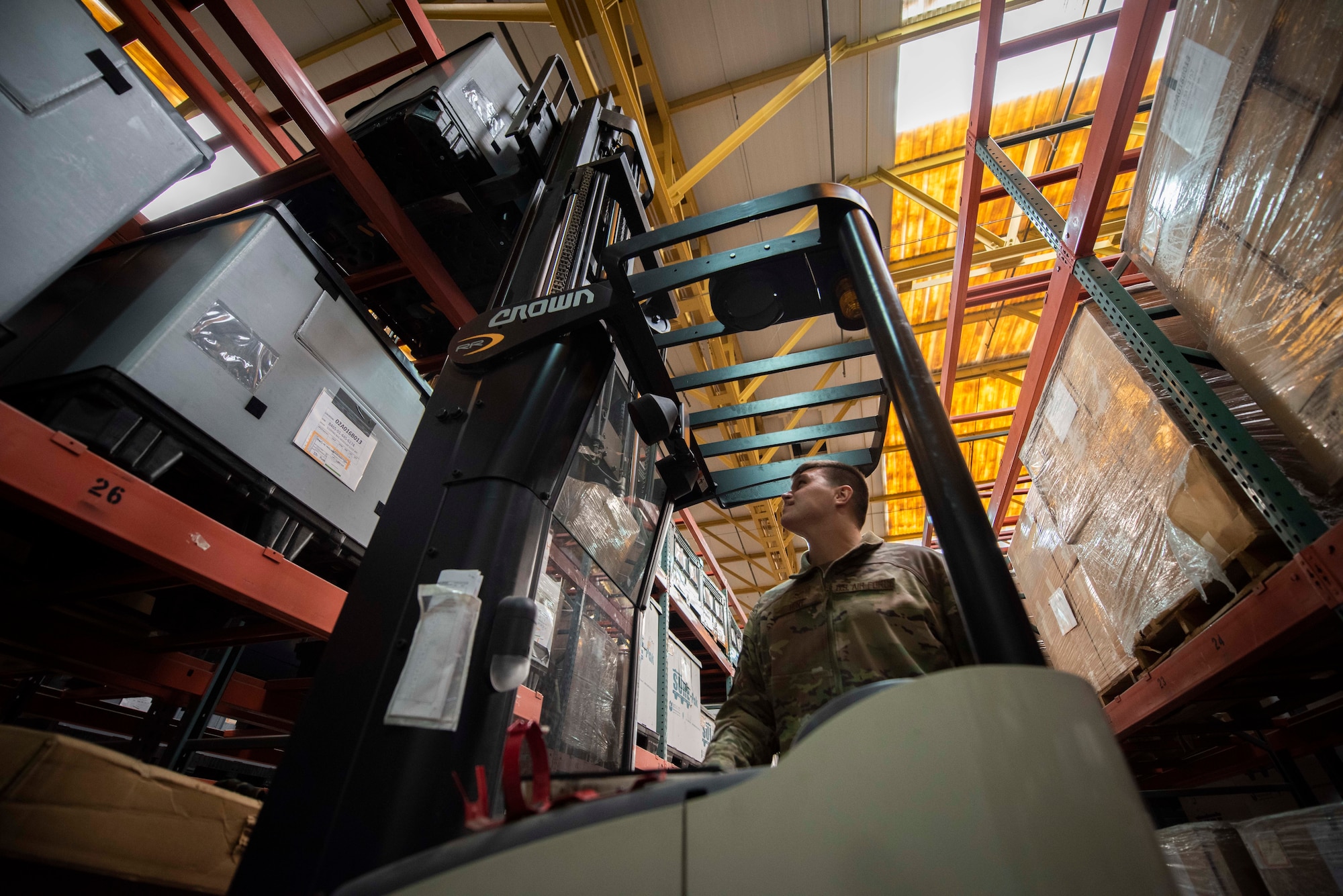 A man uses a forklift.