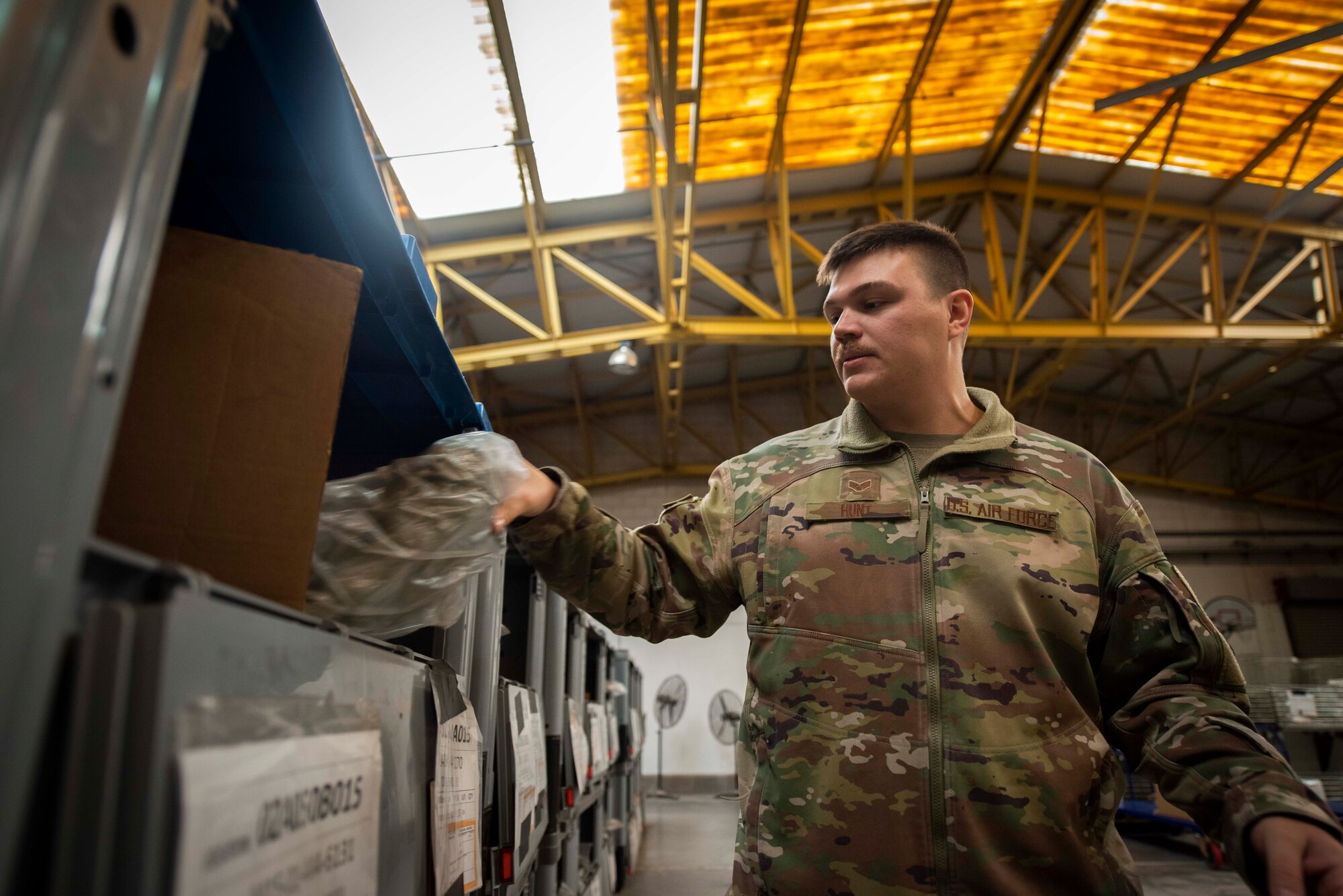 A man pulls out a package from a box.