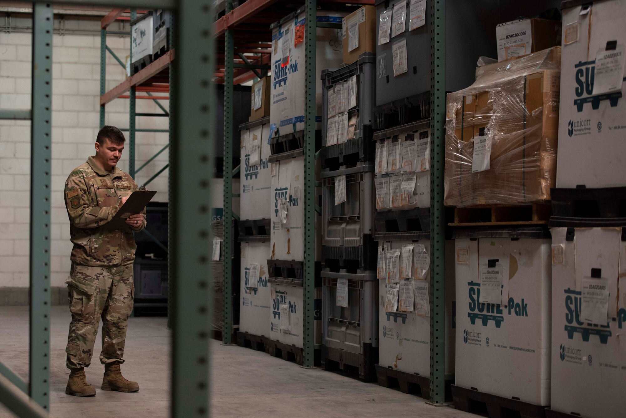 A man reads from a clipboard.