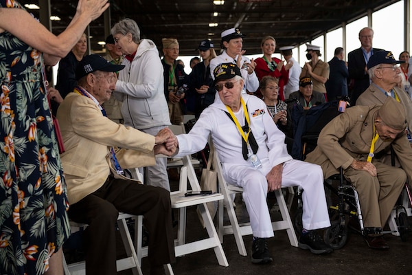 PEARL HARBOR, Hawaii (Dec. 7, 2021) Two World War II veterans thank each other for their service during the 80th Anniversary Pearl Harbor Remembrance. Dec. 7, 2021 marks the 80th anniversary of the attacks on Pearl Harbor and Oahu. The U.S. military, State of Hawaii and National Park Service are hosting a series of remembrance events throughout the week to honor the courage and sacrifices of those who served throughout the Pacific theater. Today, the U.S.-Japan Alliance is a cornerstone of peace and security in a free and open Indo-Pacific region. (U.S. Navy photo by Mass Communication Specialist 1st Class Kelby Sanders)