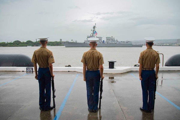 PEARL HARBOR, Hawaii (Dec. 7, 2021) Marines assigned to Marine Unmanned Aerial Vehicle Squadron (VMU) 3 stand at attention as the sailors aboard Arleigh Burke-class guided-missile destroyer USS Chung Hoong (DDG 93) render honors to the USS Arizona Memorial during the 80th Anniversary Pearl Harbor Remembrance. Dec. 7, 2021, marks the 80th anniversary of the attacks on Pearl Harbor and Oahu. The U.S. military, State of Hawaii and National Park Service are hosting a series of remembrance events throughout the week to honor the courage and sacrifices of those who served throughout the Pacific Theater. Today, the U.S.-Japan Alliance is a cornerstone of peace and security in a free and open Indo-Pacific region. (U.S. Navy photo by Mass Communication Specialist 3rd Class Jeremy Lemmon Jr.)
