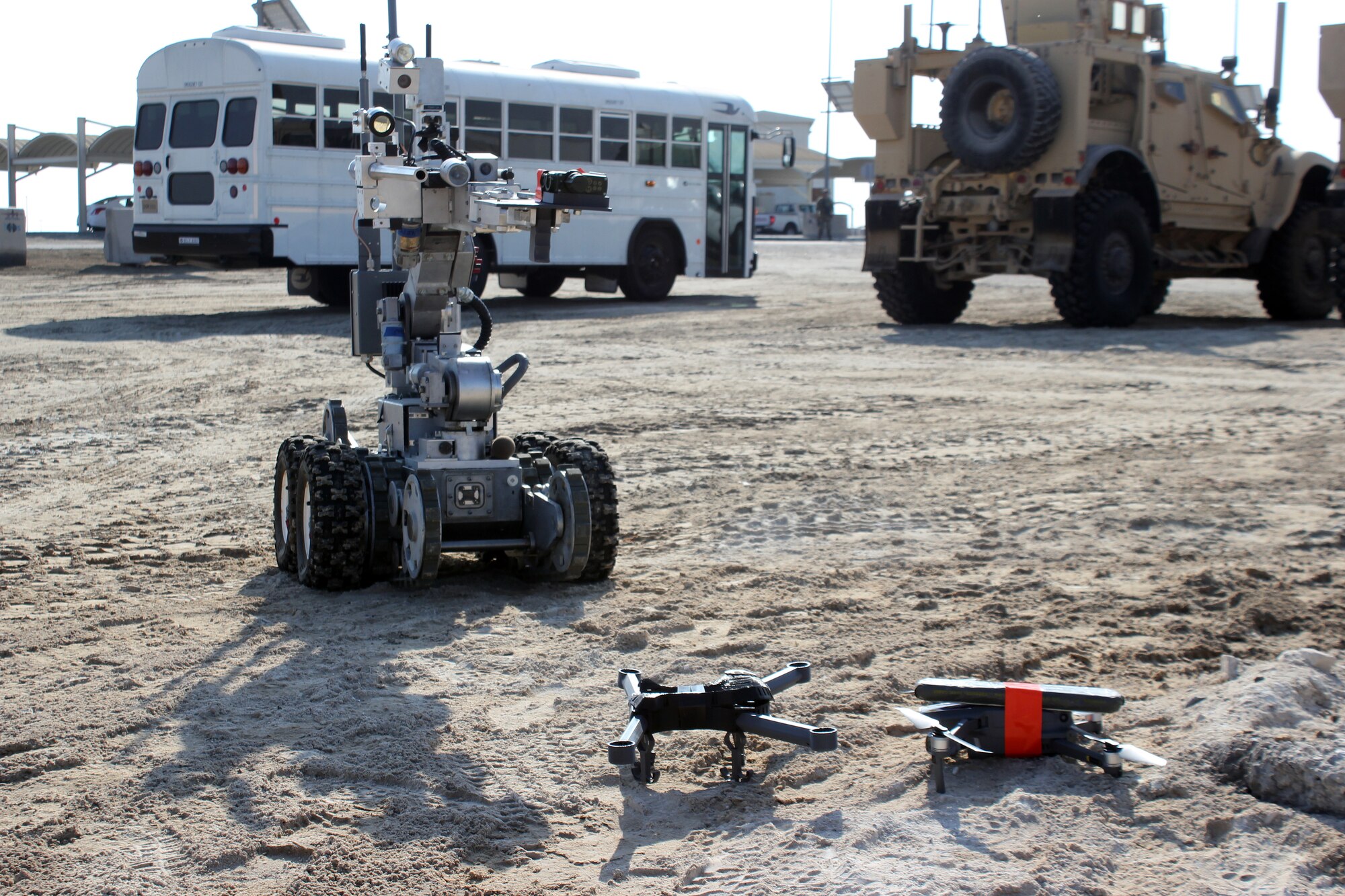A robot operated by the Explosive Ordnance Disposal team approaches two downed Unmanned Aerial Systems, armed with a simulated explosive device, during an exercise at Al Dhafra Air Base, United Arab Emirates, Dec. 3, 2021. The 380th Expeditionary Security Forces Squadron at the base has responsibility for countering potential UAS threats.