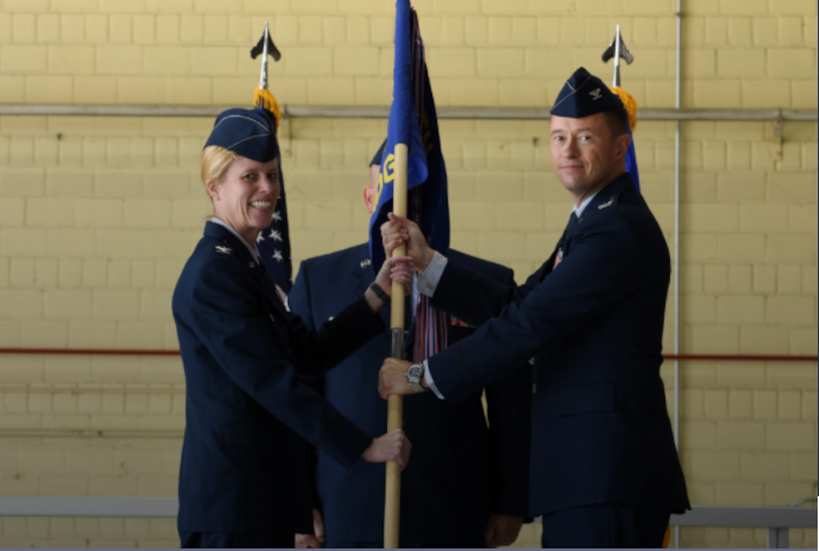 Col. Christopher Backus receives the 55th Medical Group guidon from Col. Kristen D. Thompson, 55th Wing commander, during a change of command ceremony June 8 at Offutt Air Force Base, Nebraska. Backus became the newest commander of the 55 MDG. (U.S. Air Force photo by Charles Haymond)

PHOTO BY: Charles Haymond