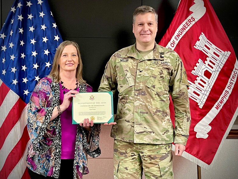 IN THE PHOTO, Commander Col. Zachary Miller presents Program Analyst Lisa Word with a Certificate of Retirement at her retirement ceremony. Word is retiring after an impressive 32 years of federal service. (USACE photos by Vance Harris)