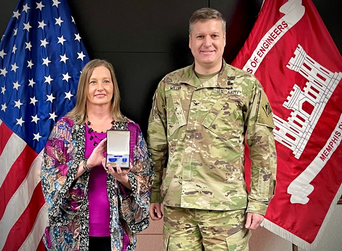 IN THE PHOTO, Commander Col. Zachary Miller presents Program Analyst Lisa Word with a Meritorious Civilian Service Medal at her retirement ceremony. Word is retiring after an impressive 32 years of federal service. (USACE photos by Vance Harris)