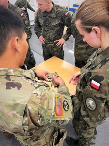 A Soldier with the Wisconsin Army National Guard’s 107th Maintenance Company demonstrates proper use of an M17 pistol to Polish troops during the unit’s mobilization to Eastern Europe as part of Operation Atlantic Resolve. The 107th mobilized in May to provide area maintenance support across Poland, Romania and Lithuania.