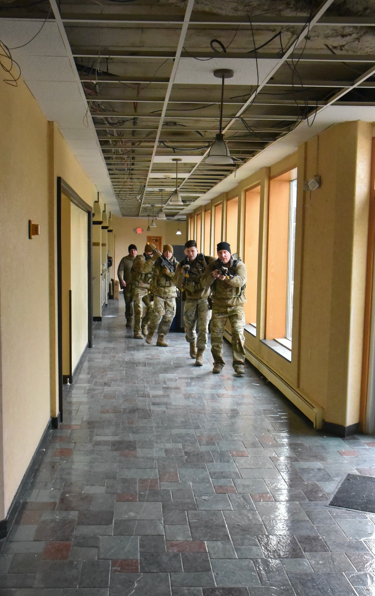Security Forces airmen from the 174th Attack Wing in Syracuse, N.Y. clear a building during a Close Quarters Battle (CQB) training at a shut-down hotel Dec. 5, 2021. CQB presents multiple techniques, tactics, and procedures and allows the unit to develop skills that ensure readiness.