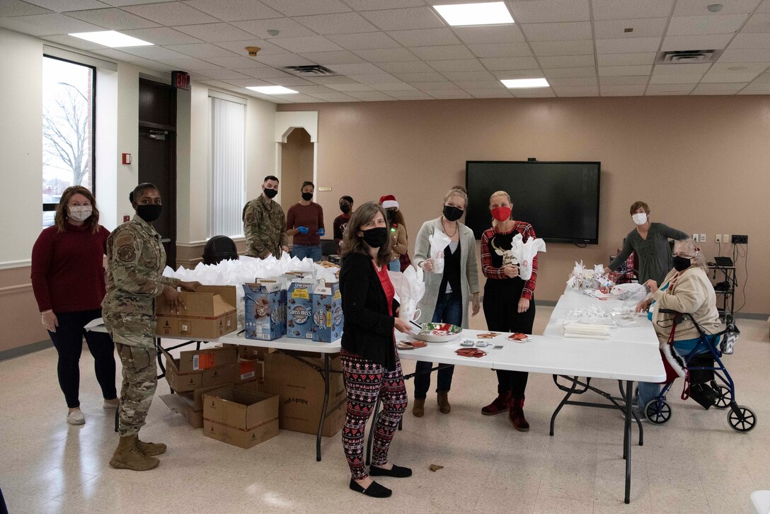 The Andrews Spouses’ Club and Airmen volunteers from the 316th Comptroller Squadron pose for a photo at Chapel 1 at Joint Base Andrews, Md., Dec. 6, 2021.