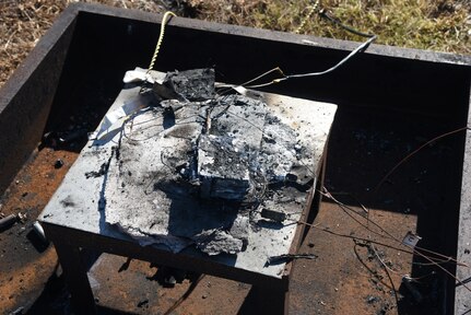 The aftermath of the first battery burn demonstration with no containment.