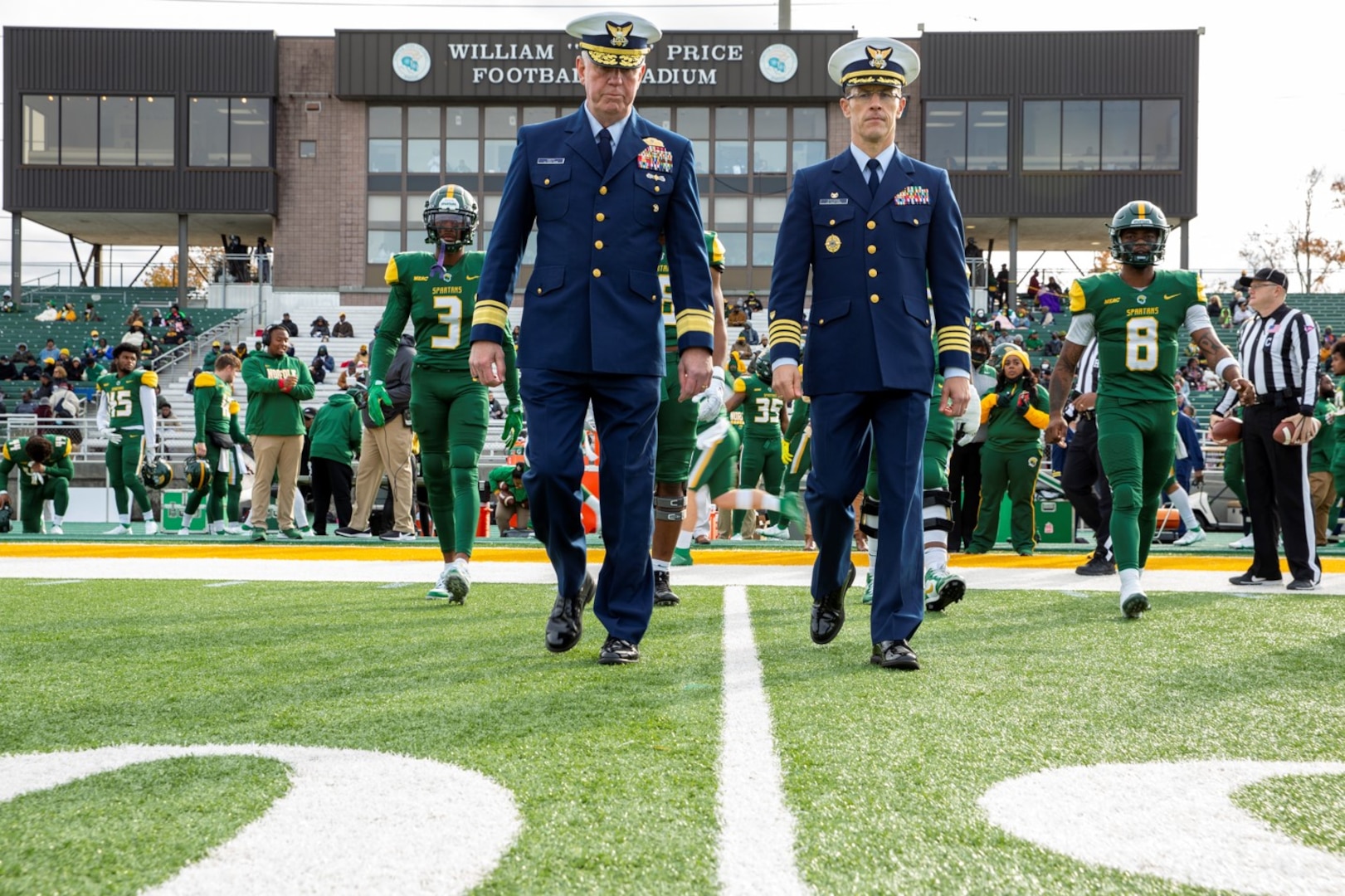Rear Adm. Keith Smith and Capt. Samson Stevens join the Norfolk State University (NSU) team captains to conduct the coin toss at the First Responders and Military Appreciation Day/Senior Day football game, Nov. 20, 2021. Photo courtesy of NSU staff.