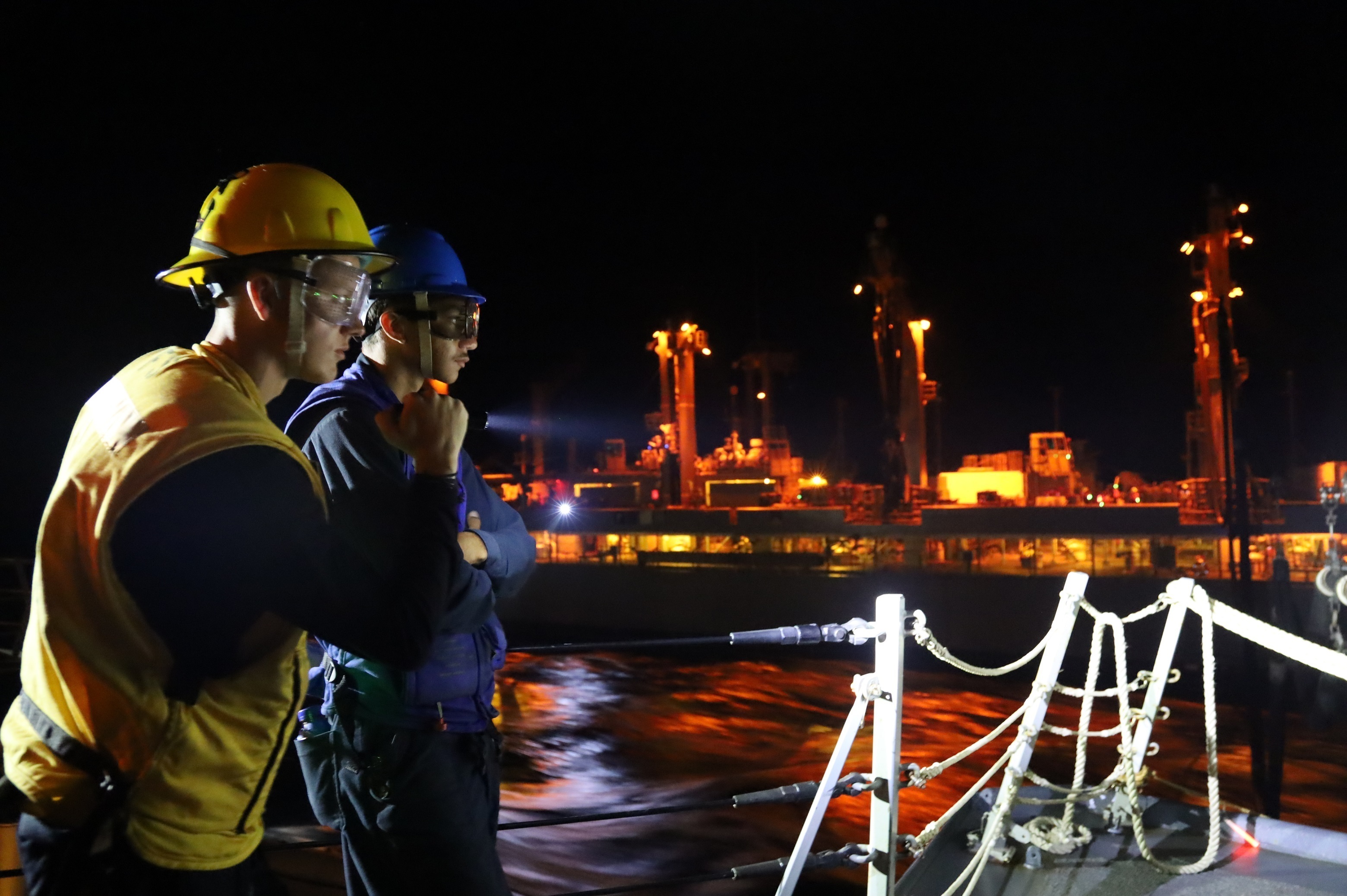 The guided-missile destroyer USS Michael Murphy (DDG 112) and the fleet replenishment oiler USNS Kanawha (T-AO 196) conduct a nighttime replenishment at sea in the Gulf of Aden.