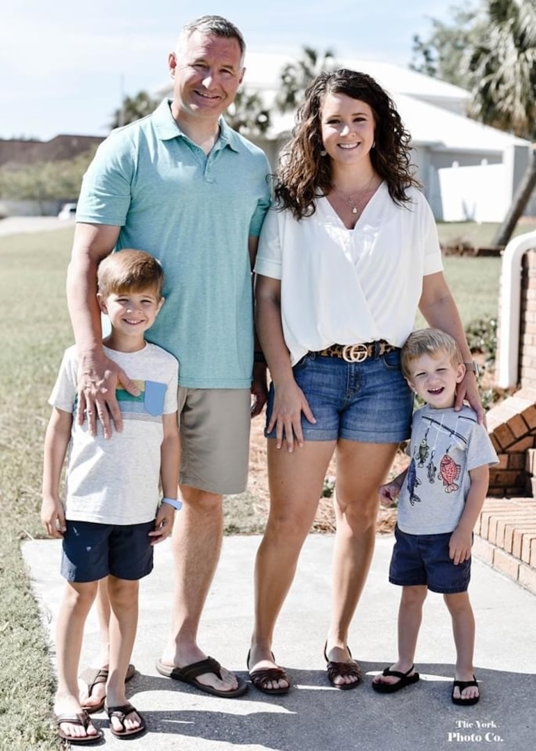 The 2020 Wanda Allen-Yearout Ombudsman of the Year awardee, Jenifer Walker, is shown (top right) with her husband, Petty Officer First Class Bradley Walker, and their two children Andersen (left) and Trent (right).