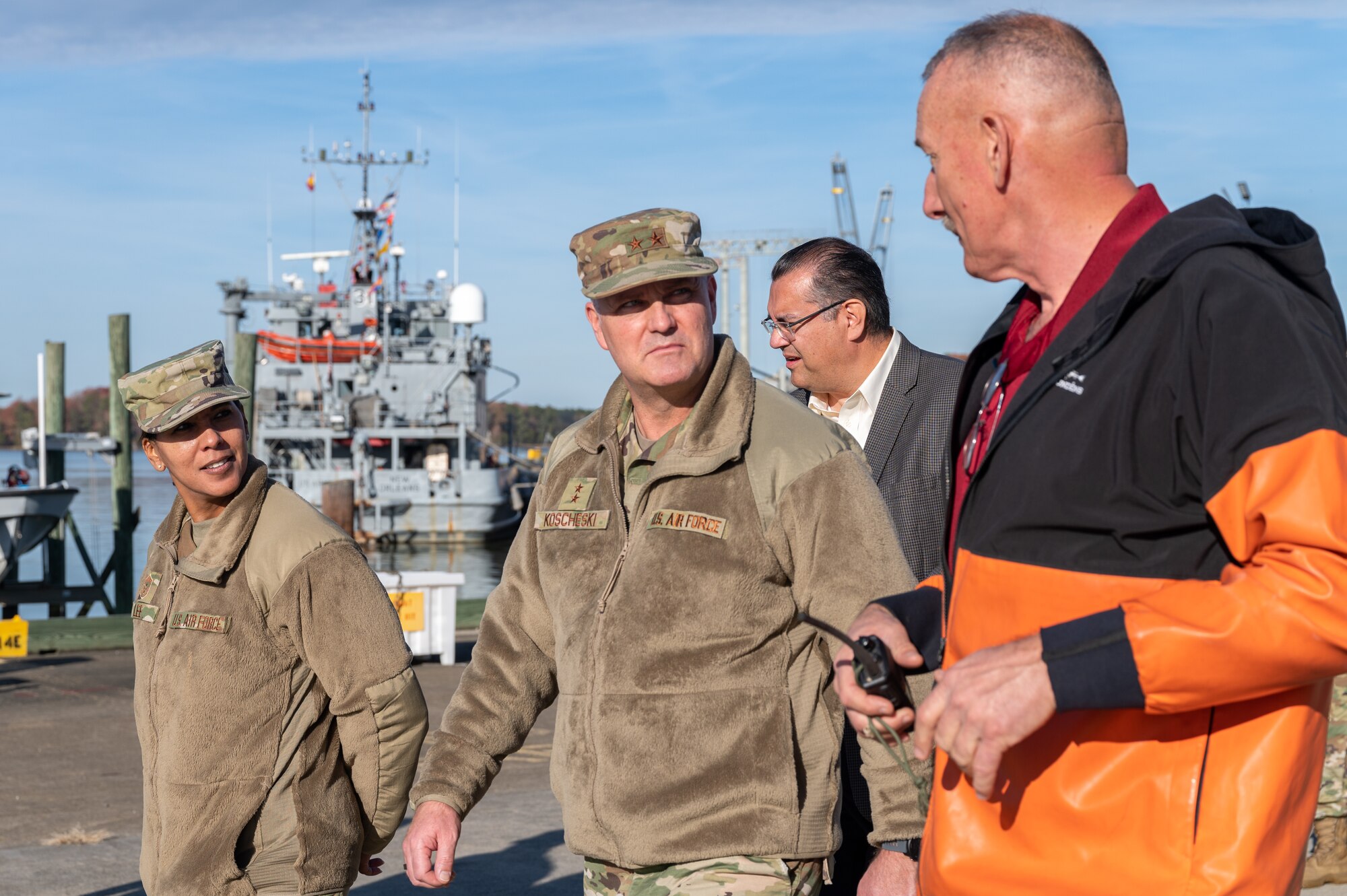 U.S. Air Force Maj. Gen. Michael G. Koscheski, Fifteenth Air Force commander, and Chief Master Sgt. Sonia T. Lee, Fifteenth AF command chief, walk and talk with Jay Dehart, 733d Logistics Readiness Squadron harbor master, at Joint Base Langley-Eustis, Virginia, Dec. 1, 2021.