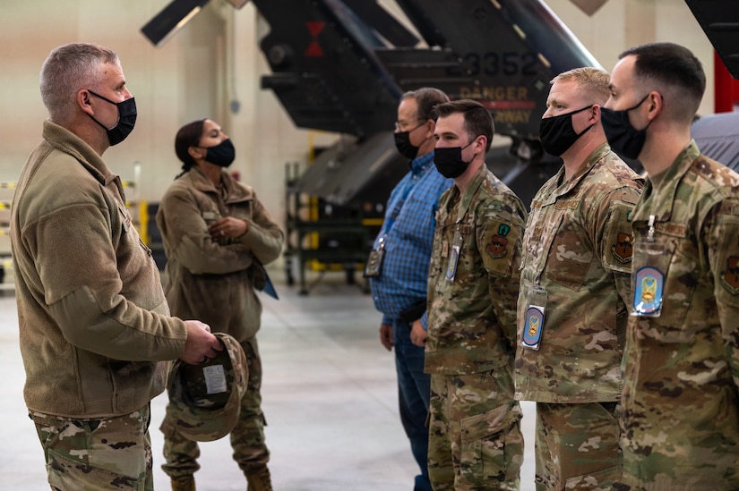 U.S. Air Force Maj. Gen. Michael G. Koscheski, Fifteenth Air Force commander, and Chief Master Sgt. Sonia T. Lee, Fifteenth Air Force command chief, speak with Sikorsky UH-60 Blackhawk crew chief training instructors with the 128th Aviation Brigade, helicopter maintenance school, at Joint Base Langley-Eustis, Virginia, Dec. 1, 2021.