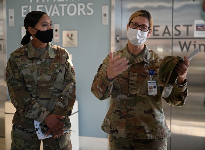 U.S. Air Force Chief Master Sgt. Sonia T. Lee, left, Fifteenth AF command chief, receives a brief from Col. Kathleen Mackey, 633rd Medical Group commander, during an immersion tour at Joint Base Langley-Eustis, Virginia, Dec. 2, 2021.