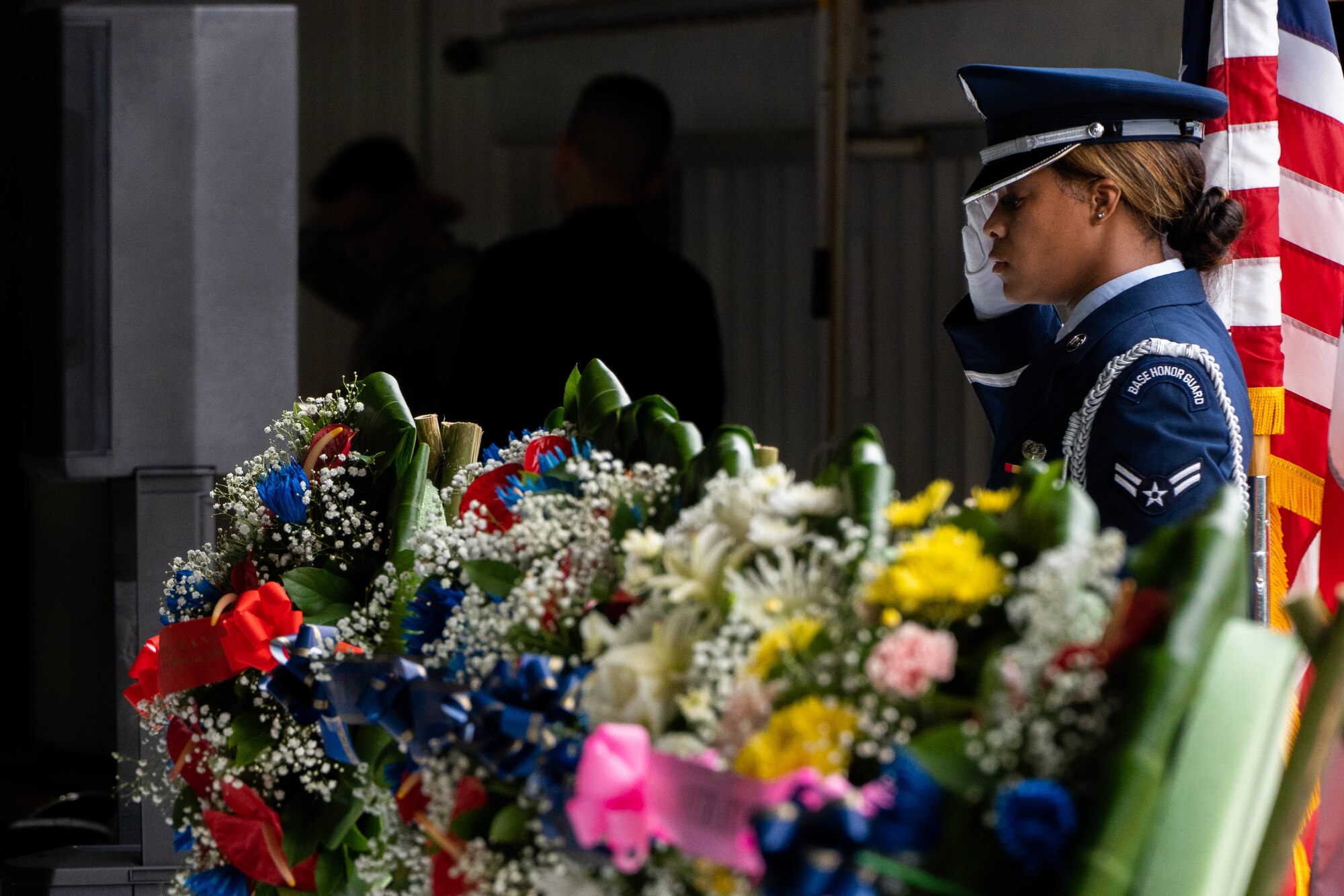 An Airman from the Base Honor Guard honors and salutes a wreath during the December 7th Remembrance Ceremony at Joint Base Pearl Harbor-Hickam, Hawaii, Dec. 7, 2021. The attacks on seven bases around the island of Oahu precipitated America’s entry into World War II. The annual December 7th Remembrance Ceremony fostered reflection and commemoration for those affected by the attacks 80 years ago. (U.S. Air Force photo by Airman 1st Class Makensie Cooper)