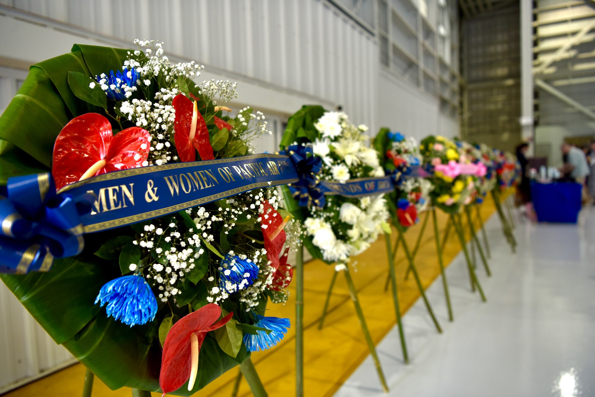 A series of wreaths are ready to be placed during the December 7th Remembrance Ceremony at Joint Base Pearl Harbor-Hickam, Hawaii, Dec. 7, 2021. Multiple organizations from across Hawaii donated a wreath in honor of those who lost their lives during the attacks on Hickam Field 80 years ago. (U.S. Air Force photo by 1st Lt. Benjamin Aronson)